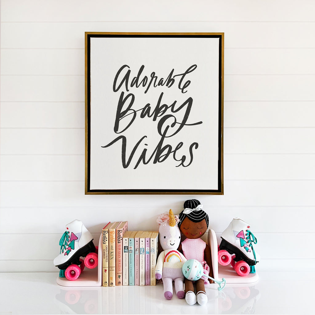 adorable baby vibes in black on alabaster framed in aged gallery brass, size 16 x 20