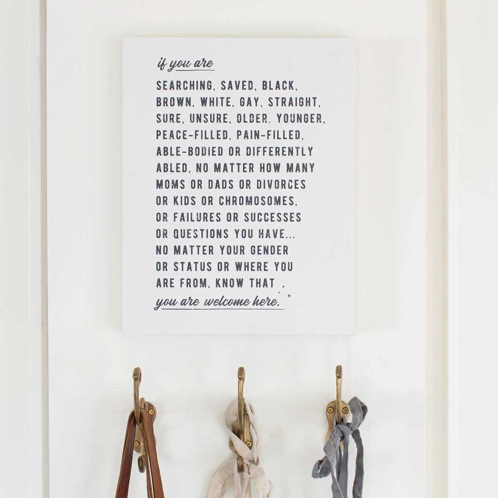 styled inspiration photo of welcome here manifesto typography artwork in alabaster